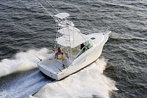 Couple on the aftdeck of a sportsfisher.  Model and property released.