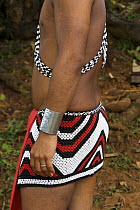 Young Embera Indian man dressed in self made traditional beaded skirt, Panama, November 2008