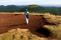 Hiker on the "Puy Pariou" in the volcano area of the Auvergne, Parque Regional des Volcans, France, August 2008