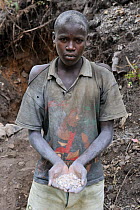 Miner with hands full of coltan metallic ore, Muhanga coltan mines, Rwanda, Africa, March 2009