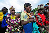 Women with babies waiting for food aid distributed by charities at Kibati village refugee camp, north of Goma, North Kivu, Democratic Republic of Congo, Africa, March 2009