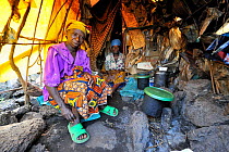 Woman cooking in her tent at the Lac Vert refugee camp, west of Goma, North Kivu, Democratic Republic of Congo, Africa, March 2009