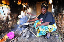 Woman cooking in her tent at the Lac Vert refugee camp, west of Goma, North Kivu, Democratic Republic of Congo, Africa, March 2009