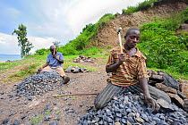 Men crushing stones for road paving near Bukavu, south Kivu, Democratic Republic of Congo, March 2009
