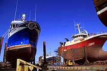 Two fishing vessels in Fraserburgh drydock undergoing hull repairs. May 2009.