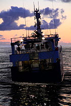 Peterhead registered fishing vessel "Harvester" winching the trawl wires onboard in calm conditions. June 2009. Property Released.