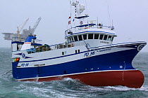 Fishing vessel "Harvester" hauling her trawl net onboard. North Sea, June 2009. Property Released.