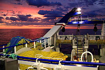 View from the aft wheelhouse window of a fishing vessel at dusk on a summer night on the North Sea. June 2009.