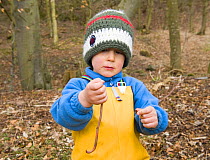 Child holding an earthworm, The Secret Garden Outdoor Nursery, Fife, Scotland