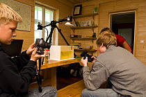 Children taking pictures of a frog, Palupohja Looduskool, Estonia