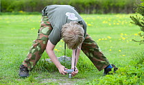Boy taking photograph of ants, Palupohja Looduskool, Tartumaa, Estonia, May