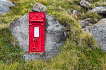 Traditional red Victorian postbox cut into a rock, Redpoint, Wester Ross, Scotland, October