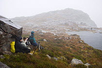 Photographers above Coire nan Arr in bad weather, Wester Ross, Scotland, October