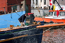 Cricketer Jack Russel breaking champagne over bow of Bristol Pilot Cutter "Morwenna" during launch ceremony, 4th April 2009. Bristol Floating Harbour, UK.
