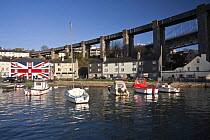Saltash waterfront in the early morning, showing the Union Inn pub and Brunel's Royal Albert (railway) Bridge. Cornwall, UK. April 2009.