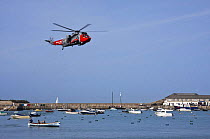 Royal Navy helicopter flying over Cornish Pilot Gig off Town Beach, St. Mary's, Isles of Scilly. World Pilot Gig Championships, May 2009.