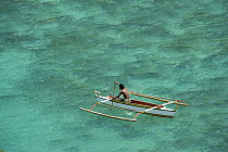 Fisherman on traditional local outrigger boat, near Pitogo Island, Caramoan Peninsula, Philippines. 2008