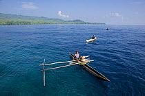 Papuans in traditional dug-out fishing canoes, Papua New Guinea. 2008