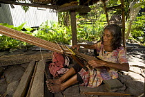 Old Ifugao woman with goiter weaving using a back-strapped loom, Banaue Rice Terraces, Philippines.  UNESCO World Heritage Site 2008