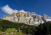 Fresh-fallen snow in the Sella Group with mountain chalets in foreground, Dolomite Alps, Italy, September 2008