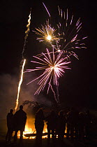 People standing in front of a bonfire watching fireworks, Guy Fawkes night, 5 November 2007, Port Howard, Northern end of West Falkland, Falkland Islands