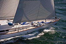 The crew collects the spinnaker on the deck of "Timoneer," a 147' Vitter's yacht while racing upwind during the Newport Bucket Regatta, July 2009, Rhode Island, USA.