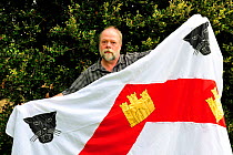 Lord Saumarez holding the blazon of his ancestors. He is the straight descendant of Admiral James Saumarez, who was a commander of Admiral Nelson, and his family has lived on Guernsey since 1120. Chan...