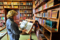 Visitor reading at the Library De Beauvoir, where the archives of the island are maintained, St Peter Port, Guernsey, Channel Islands. May 2009.