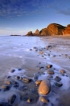 Tide washing over pebbles at Sandymouth bay, north Cornwall, UK. January 2009.