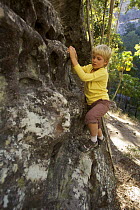 Russell Laman (8 years) climbing on sandstone rock formations in Carnarvon Gorge, Carnarvon National Park, Queensland, Australia. Model released August 2008
