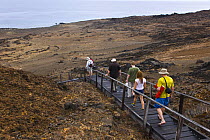 Tourists walking along walkway on Bartolome Island, Galapagos, January 2009