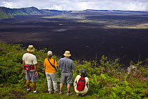 Hikers admire the view from the caldera rim of the Chico Volcano, Sierra Negra, Isabela Island, Galapagos, January 2009