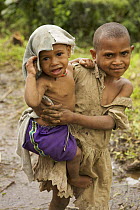 Tari valley girl looking after her younger sibling, Tari Valley vicinity, Southern Highlands Province, Papua New Guinea, September 2006