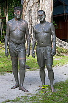 Stephen Fry and Mark Carwadine after a mud bath in Borneo, filming for BBC TV series 'Last Chance to See', March 2009