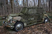 Stone sculpture of Volkswagon Car in woodland, near Ithaca, NY, USA