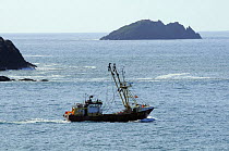 Fishing trawler heading out to sea from Padstow, Cornwall, UK.