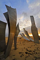 The Omaha Beach monument Les Braves, memorial to the D-Day landings, on the beach at Saint-Laurent-sur-Mer at sunset, Normandy, France, September 2008