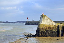 Harbour wall and lighthouse at Saint-Vaast-la-Hogue, Normandy, France, December 2008