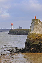 Harbour wall and lighthouse at Saint-Vaast-la-Hogue, Normandy, France, December 2008