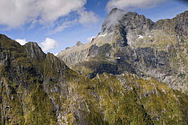 Fiordland National Park, South Island, New Zealand, with tourist helicopter flying in the distance, January 2009