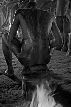 Young men searing their body scars with heat after the initiation ceremony in which scars are cut into their flesh to represent the men being swallowed by a crocodile and reborn as crocodile-men, Papu...