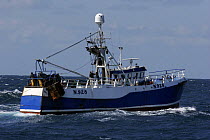 Crewmen on Irish registered "Rebecca Elizabeth" shooting their trawl nets to start a new fishing haul. North Sea, May 2008.