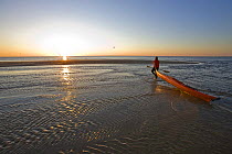 A man taking sea kayak at dawn to sea at the Shifting Lots Preserve in Plymouth, Massachusetts, USA. Owned by the Wildlands Trust. Cape Cod Bay. Near Ellisville Harbor State Park. Model Released. May...