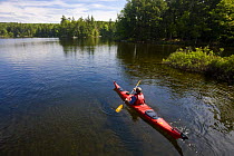 A man kayaking on Branch Lake in Ellsworth, Maine, USA. Model Released. June 2008