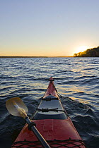 A kayak at dawn on Lake Winnipesauke in Meredith, New Hampshire, USA. October 2008