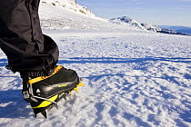 A winter hiker's crampon equipped boot on Mount Clay above the Great Gulf, Gulfside Trail, Northern Presidential mountain range, White Mountains, New Hampshire, USA. Model Released. March 2008