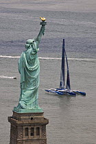 Maxi trimaran "Banque Populaire V", skippered by Pascal Bidégorry, arriving in Manhattan, New York, for North Atlantic record attempt. Passing the Statue of Liberty, 27 June 2009.