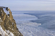 Cape Thompson and an open lead in the pack ice, blown open by strong winds, indicating thinning sea ice conditions, 26 miles south of Point Hope, Arctic coast of Alaska, March 2008