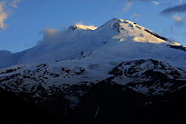 Mount Elbrus, the highest mountain in Europe (5,642m) seen from Mount Cheget in the first light of the morning showing both summits, Caucasus, Russia, June 2008