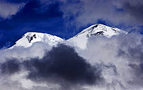 Mount Elbrus, Europes highest mountain (5,642m) surrounded by clouds, Caucasus, Russia, June 2008